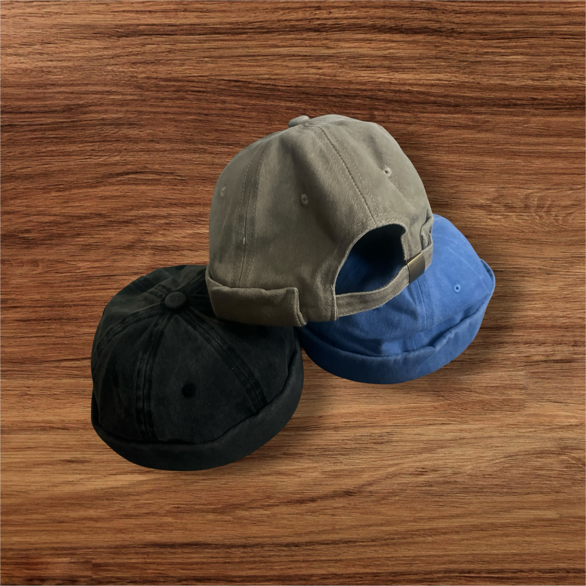 Peacefulcornerapparel distressed cotton docker hat in black, grey, and blue with adjustable strap.